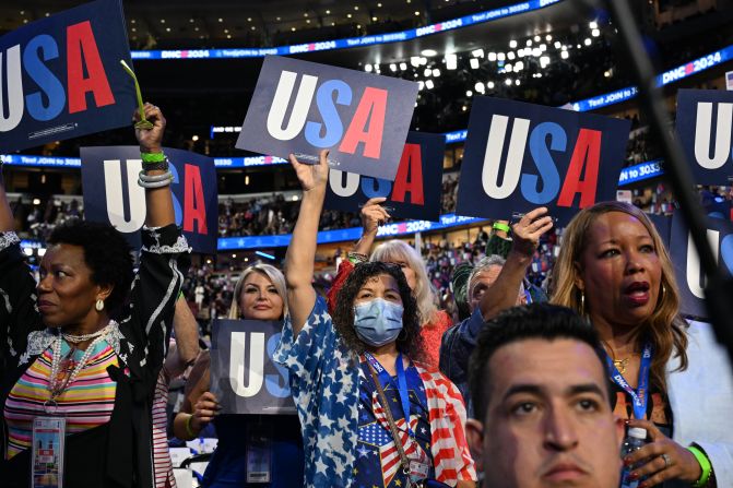 People hold USA signs at the United Center on Tuesday.