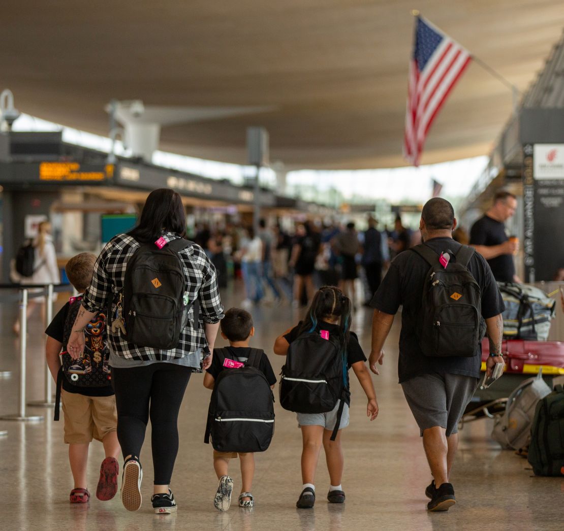 The Mendoza family walks toward their gate after checking in for their flight to Mexico.