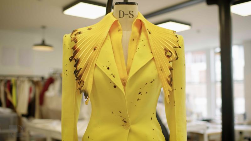 Robert Wun hand makes a 0,000 dress. Then he burns holes in it