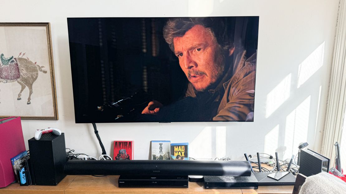 Pedro Pascal as Joel in “The Last of Us” appears on a TV above the Sonos Arc.