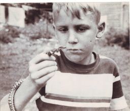 A young Romulus Whitaker holds up a milk snake circa 1947 in Hoosick, New York.