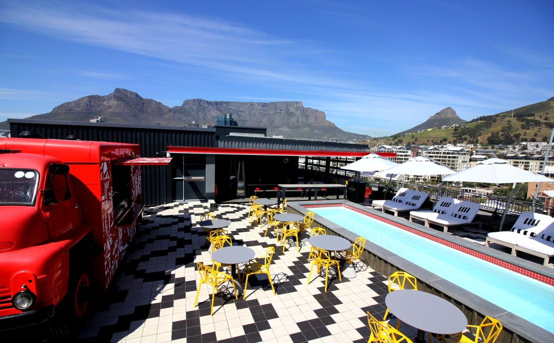 In addition to community projects, Mpahlwa's team also designs commercial properties, including the Radisson RED hotel in Cape Town. Pictured: the view from the rooftop pool at the hotel, with Table Mountain in the background.