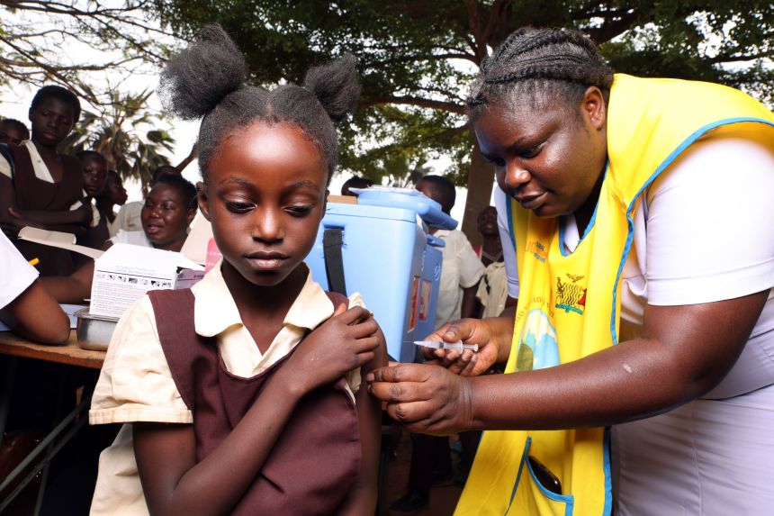 Workers provide HPV vaccines to schoolchildren in Zambia. WHO has a goal target of vaccinating 90% of girls under 15 against HPV by 2030, along with screening and treatment targets for adult women.