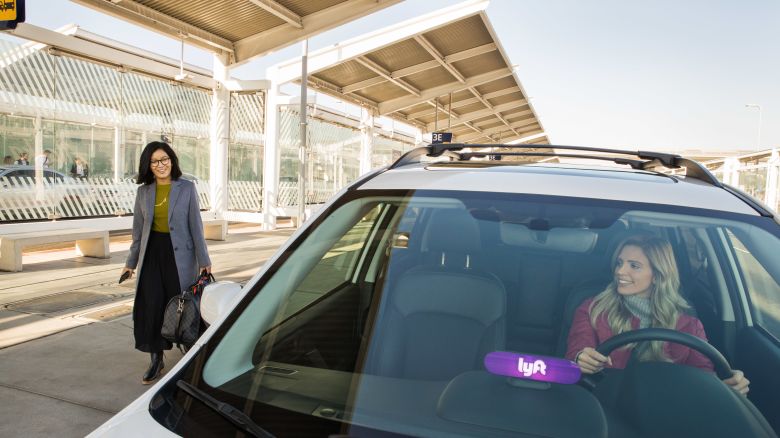 A photo of a person getting into a Lyft vehicle at an airport