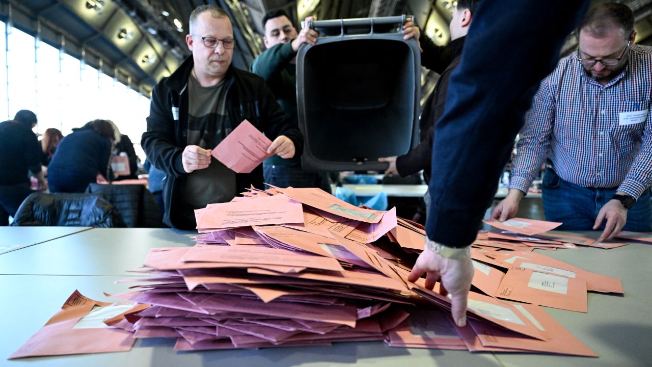 People sort and count ballots in the postal voting centre in Frankfurt am Main, western , on February 23, 2025, during the German federal elections day. Germans began voting on February 23, 2025 in a pivotal election, with the conservatives the strong favourites after a campaign rocked by a far-right surge. (Photo by Kirill KUDRYAVTSEV / AFP) (Photo by KIRILL KUDRYAVTSEV/AFP via Getty Images)