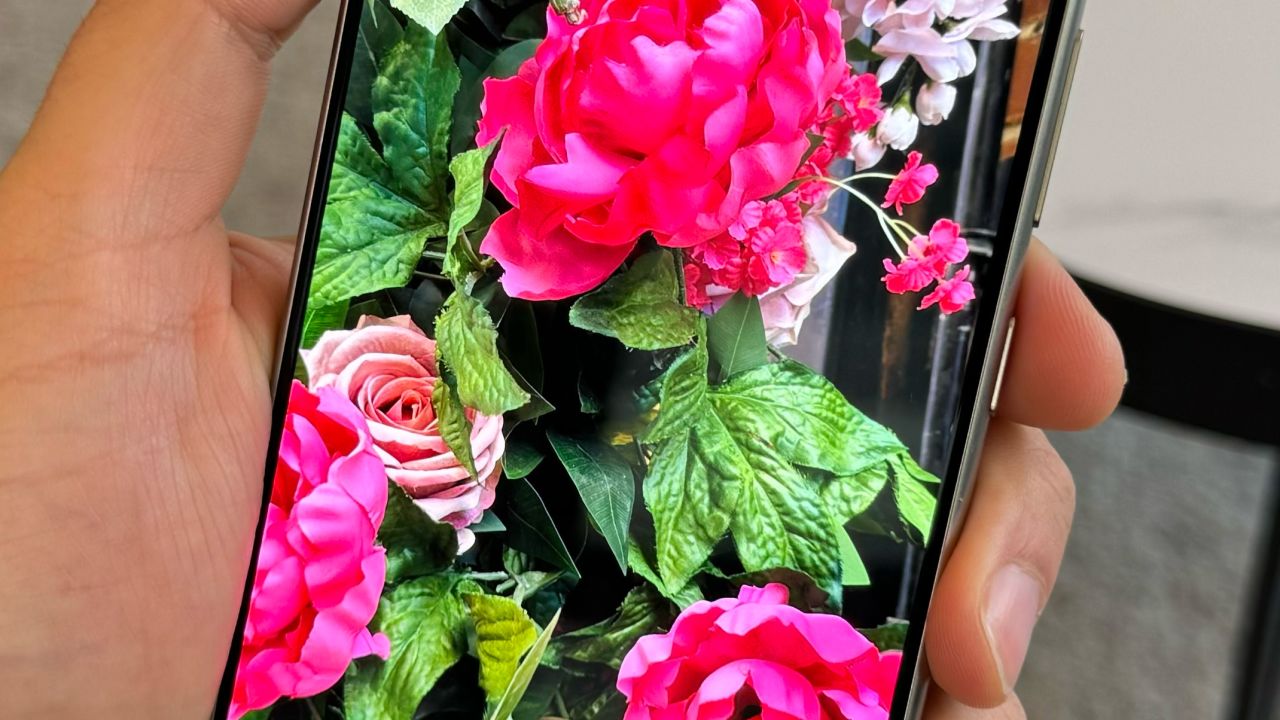 A hand holds the Galaxy S24 Ultra displaying a photo of a fake rose