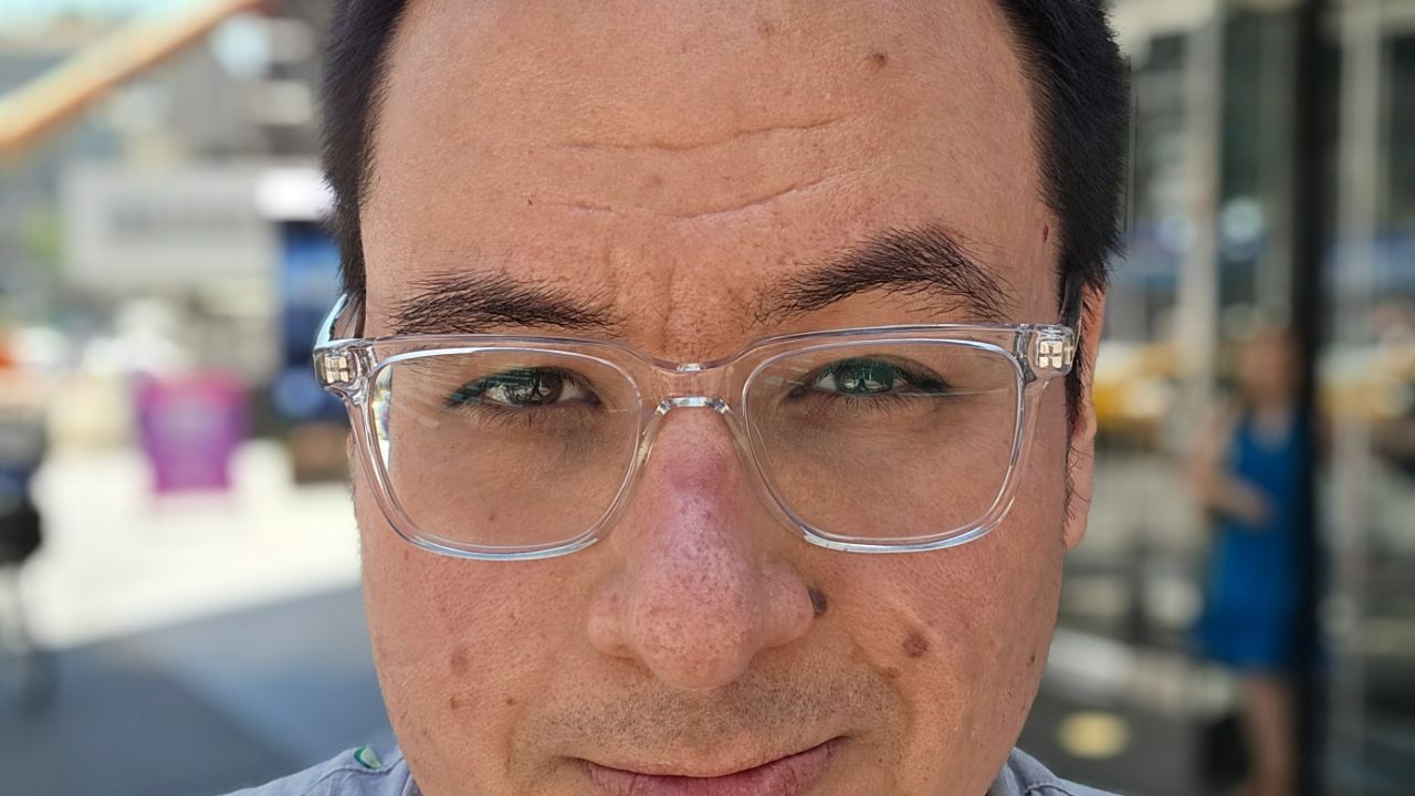 A Portrait Mode selfie of the author in a busy sidewalk