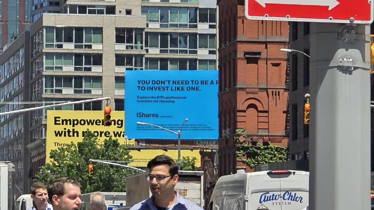 A view of NYC with a blue sign in the distance. If you look closely you can see the texture of the sign has basically been flattened