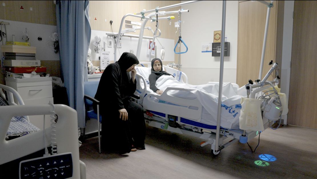Sabha Al-Soury comforts her daughter Ola at the hospital in Doha. In addition to having lost members of their family, they worry about the fate of those still left behind.