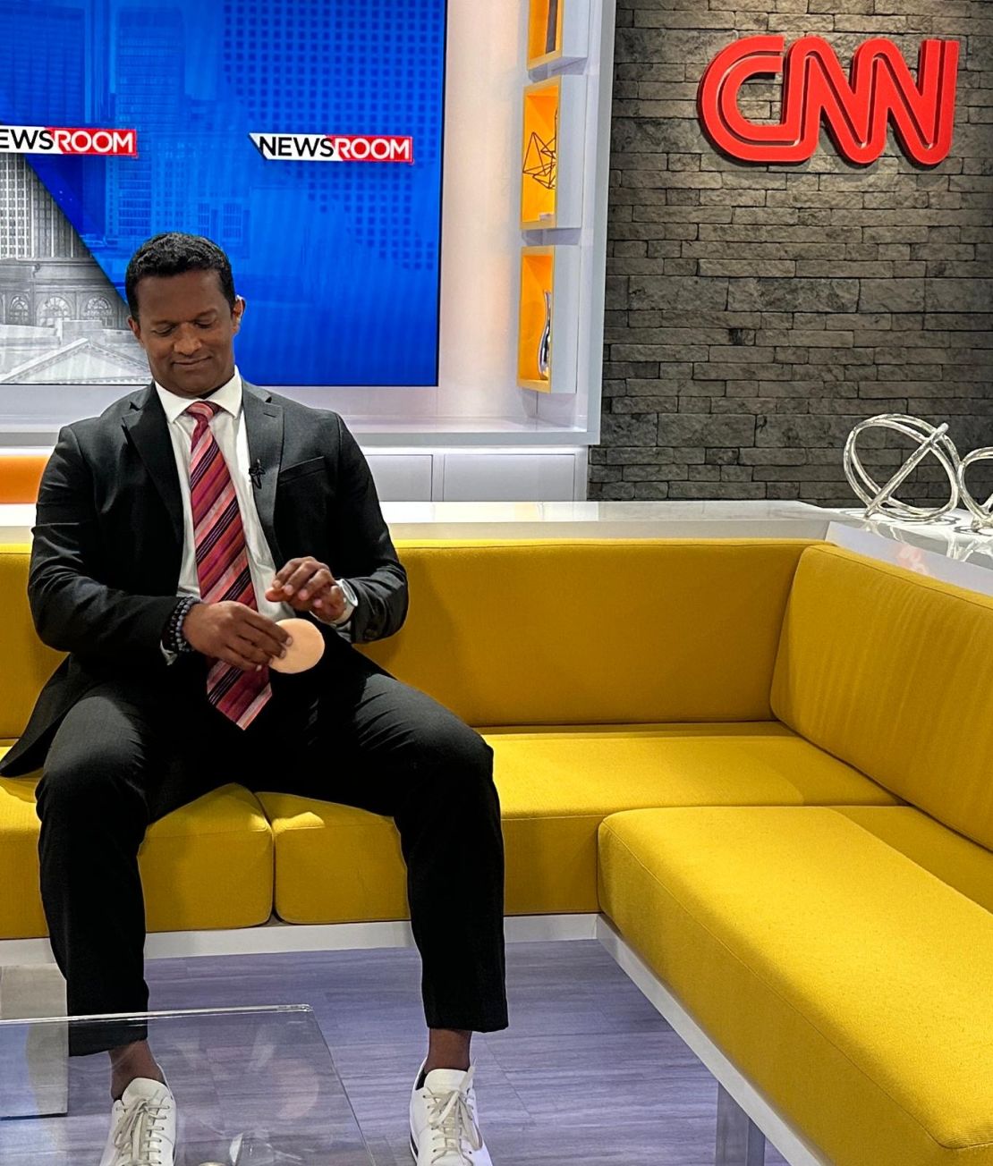 Dr. Mathew getting ready at CNN's studios in Atlanta for a segment last May. He's been a medical analyst at the network since 2020.