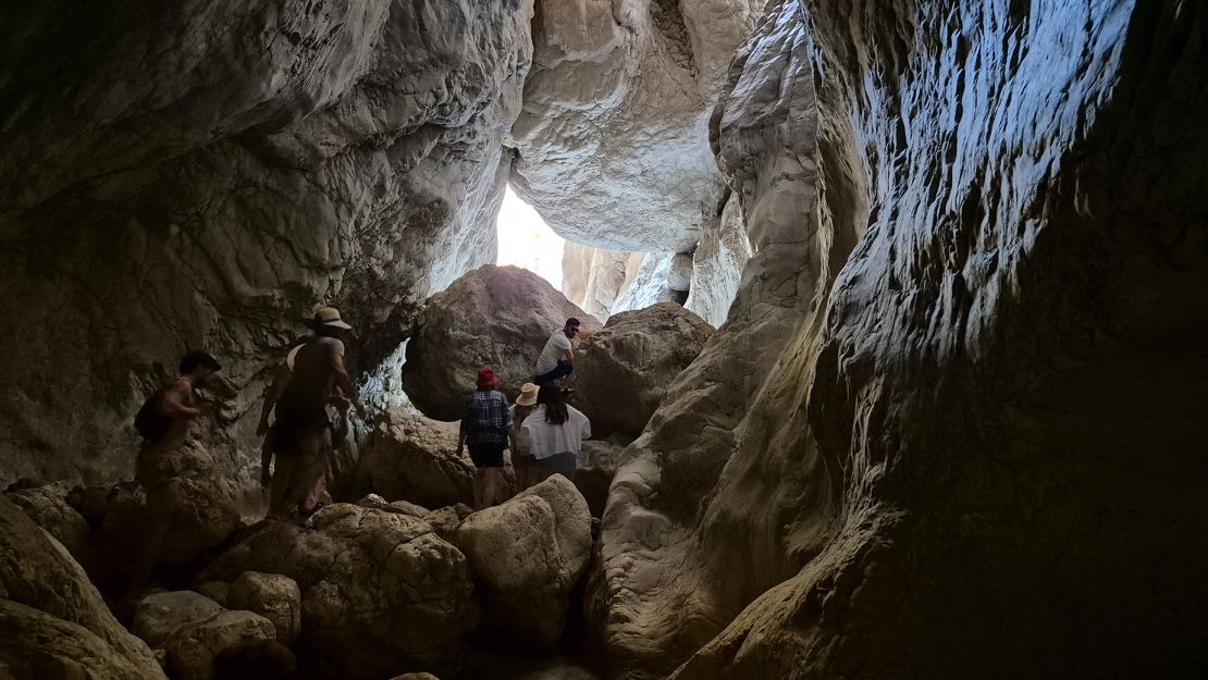 A final clamber through a cave-like chamber leads up to a waterfall.