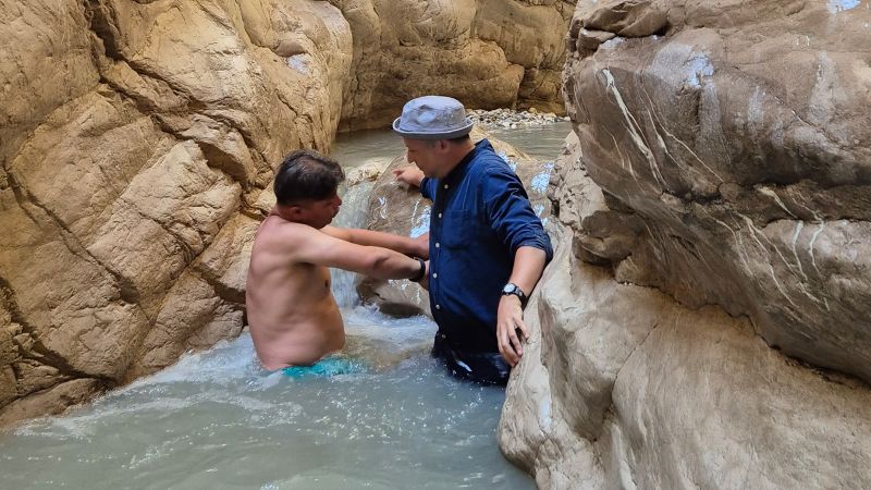 The ‘Hidden Valley’ where tourists wade through icy water to reach a secret waterfall | CNN