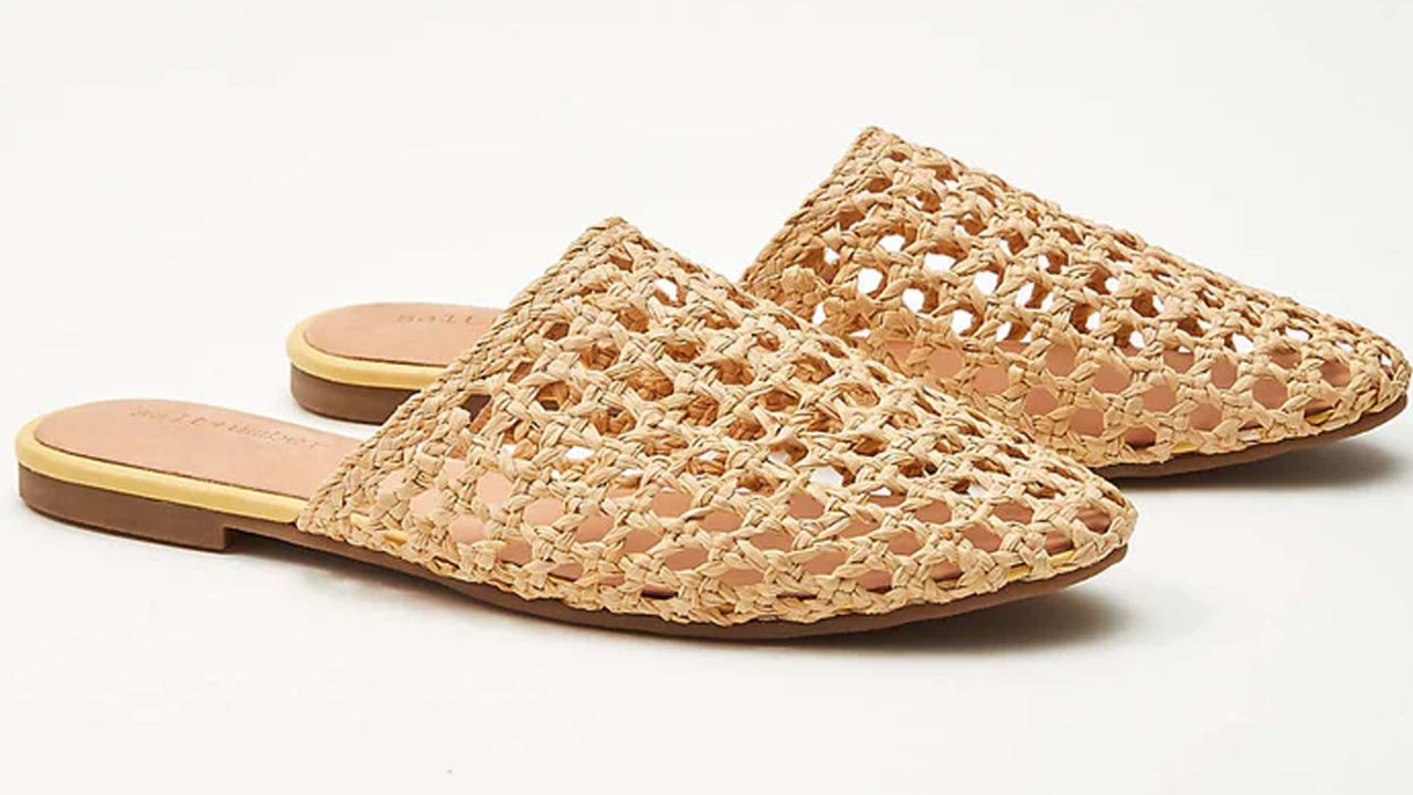 A beachy chic natural seagrass mule with an open weave silhouette