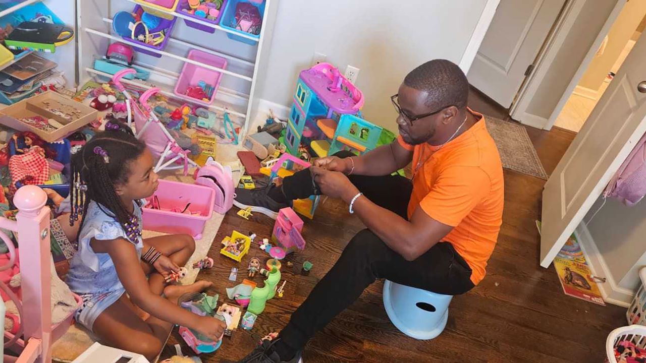 Sam Kangethe talks to his daughter, Ella, one last time shortly before he leaves for the airport.