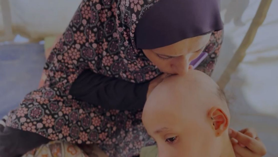 Sama Tubail’s mother, Om-Mohammed, kisses her daughter’s head.