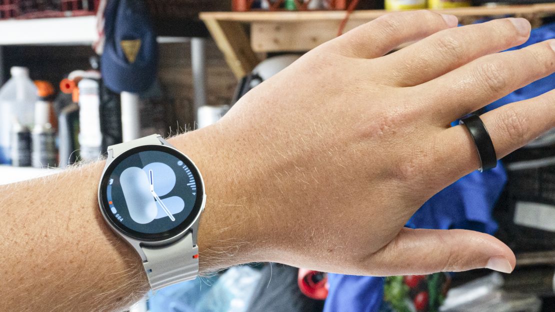 Hand wearing both Samsung Galaxy Ring and smartwatch.