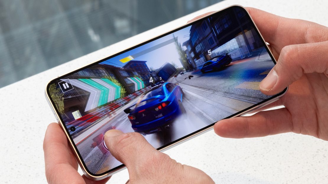 A racing video game is played on a Samsung smartphone.