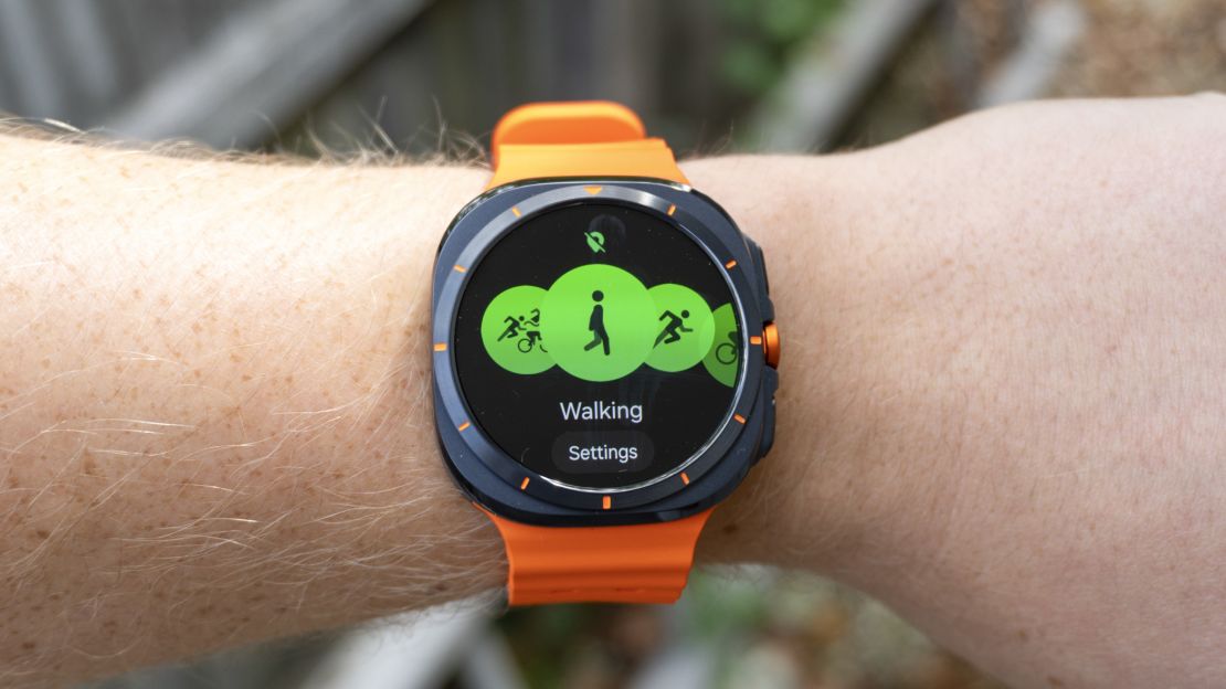 Samsung Galaxy Watch Ultra with walking fitness feature on screen.