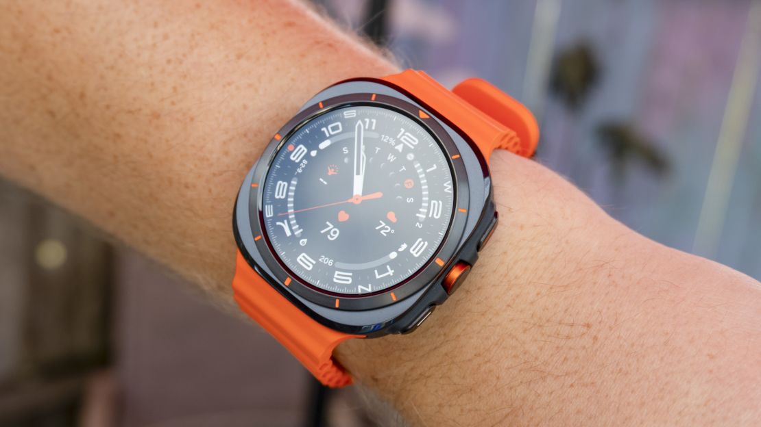 Orange Samsung Galaxy Watch Ultra on a person's wrist.