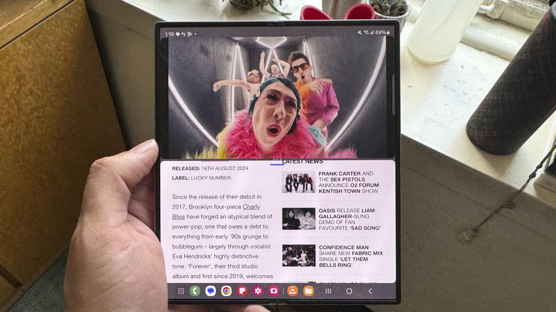 The Samsung Galaxy Z Fold 6 interior screen is split between a video of the band Charly Bliss and an article about them 