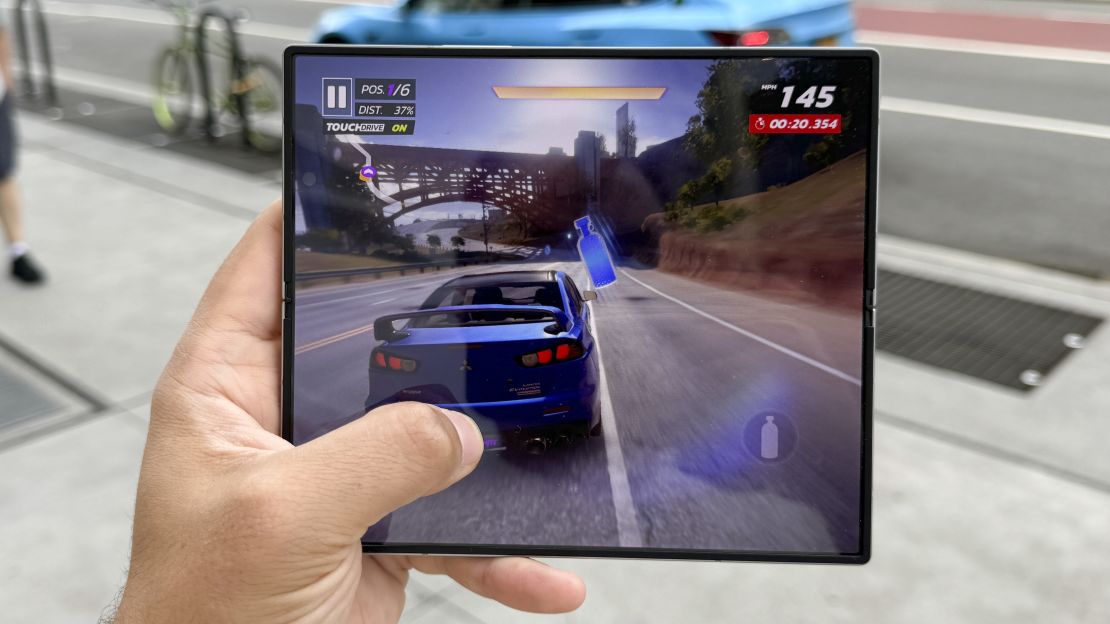 A car is driving down a road in the Asphalt Legends Unite game on the Samsung Galaxy Z Fold 6