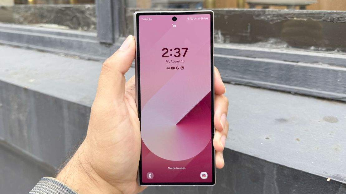 The Samsung Galaxy Z Fold 6 seen from the front, closed, and a pink lock screen visible