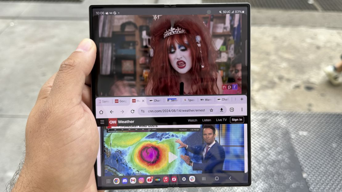 The Samsung Galaxy Z Fold 6 screen is split between the Chappell Roan tinydesk video and Chrome where many tabs are open, and we're seeing a CNN story about the weather.