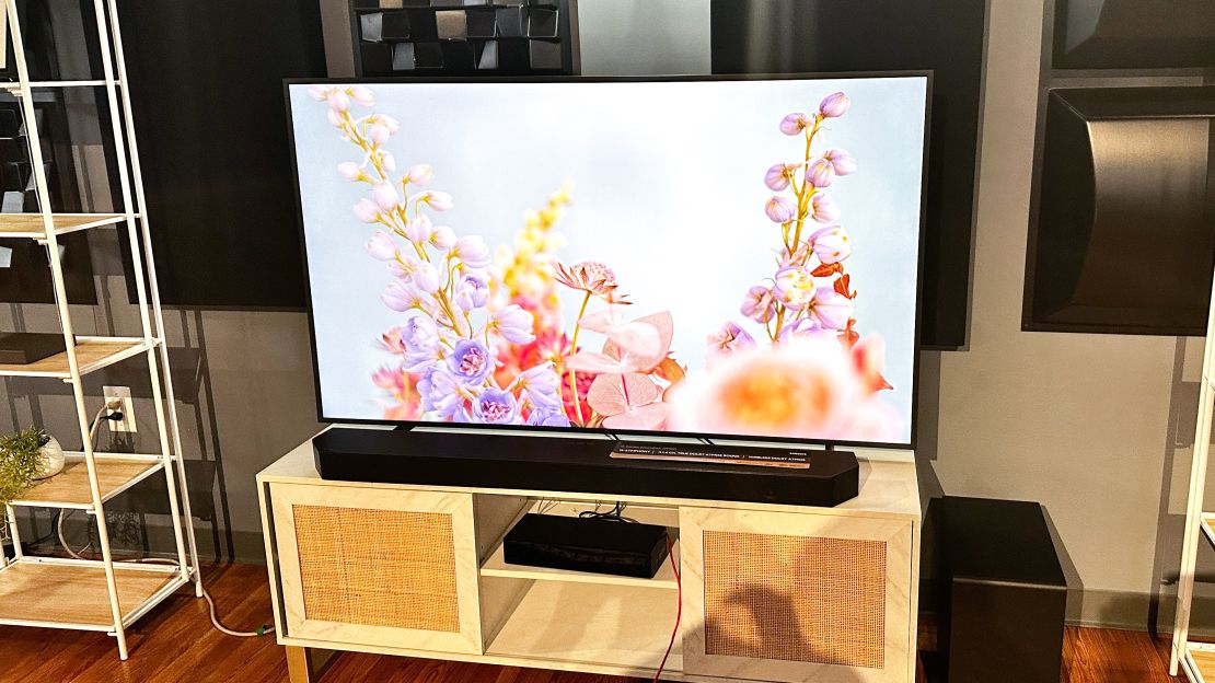 Samsung's The Frame TV in a living room setup. It's on a white TV console.