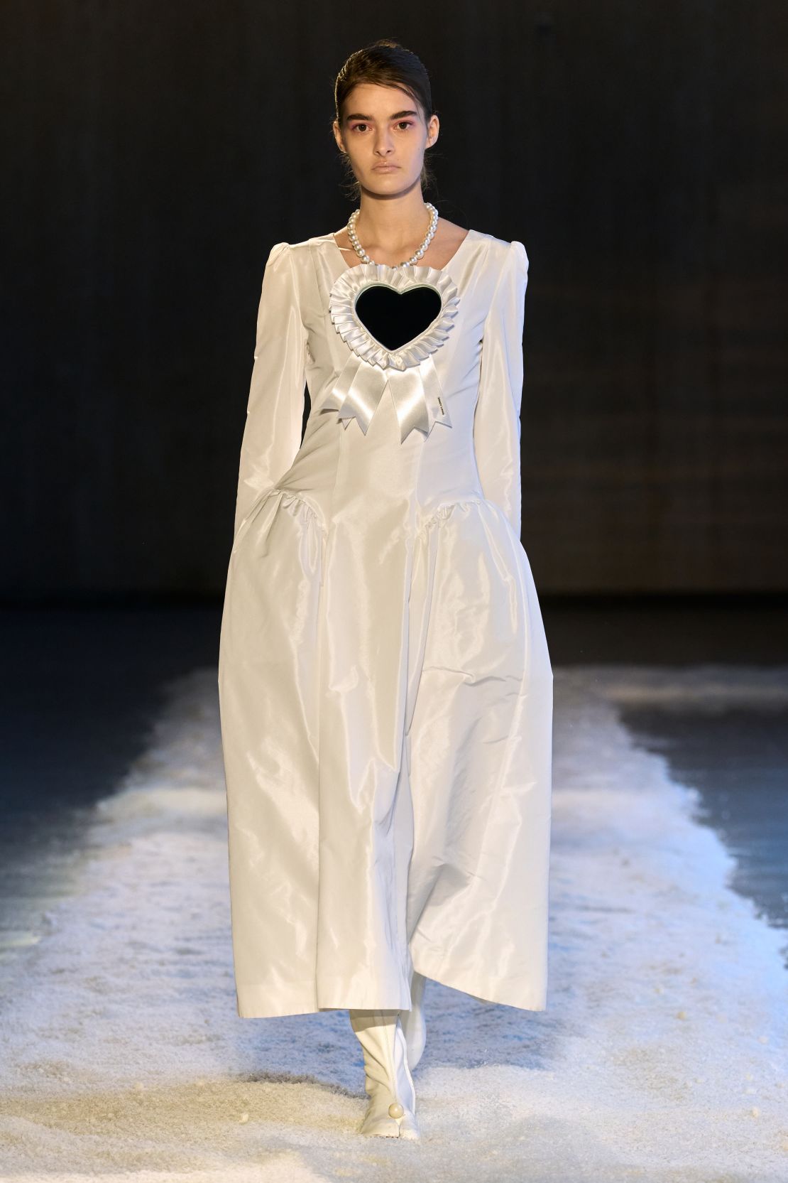 Heart mirrors repeated throughout the collection including this oversized version on a dropwaisted white dress.