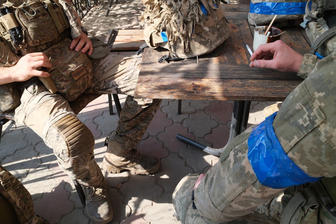 A group of Ukrainian soldiers rests after completing a long mission in Russia's Kursk region.