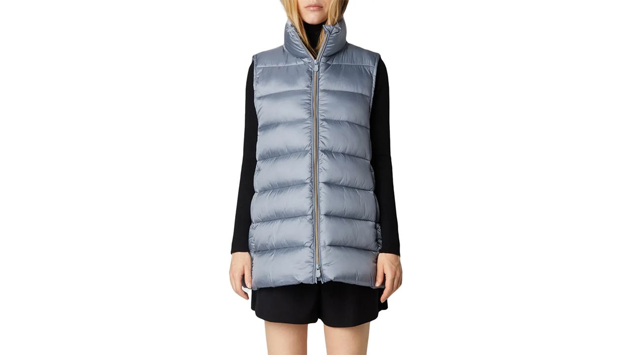 A photo of a person wearing a blue Save the Duck Women’s Coral Puffer Vest