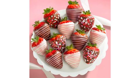 A gift inside chocolate covered strawberries