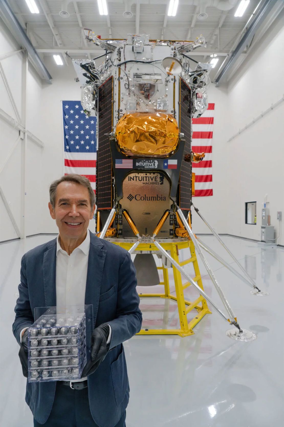 Jeff Koons poses with his moon-bound artwork.