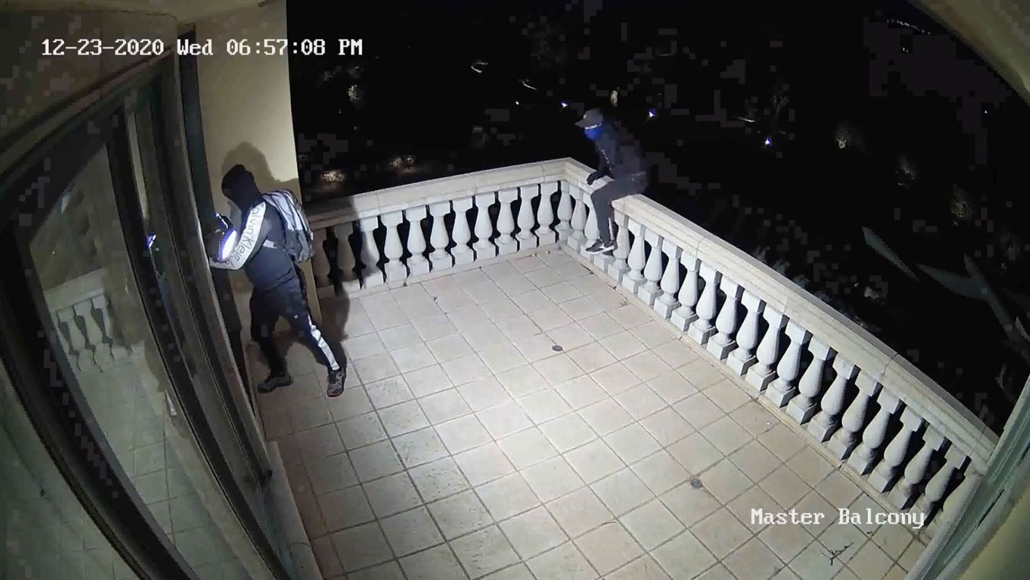 A group of thieves is seen breaking into a home through a window in the upper bedroom in a video released by the Orange County District Attorney's Office.