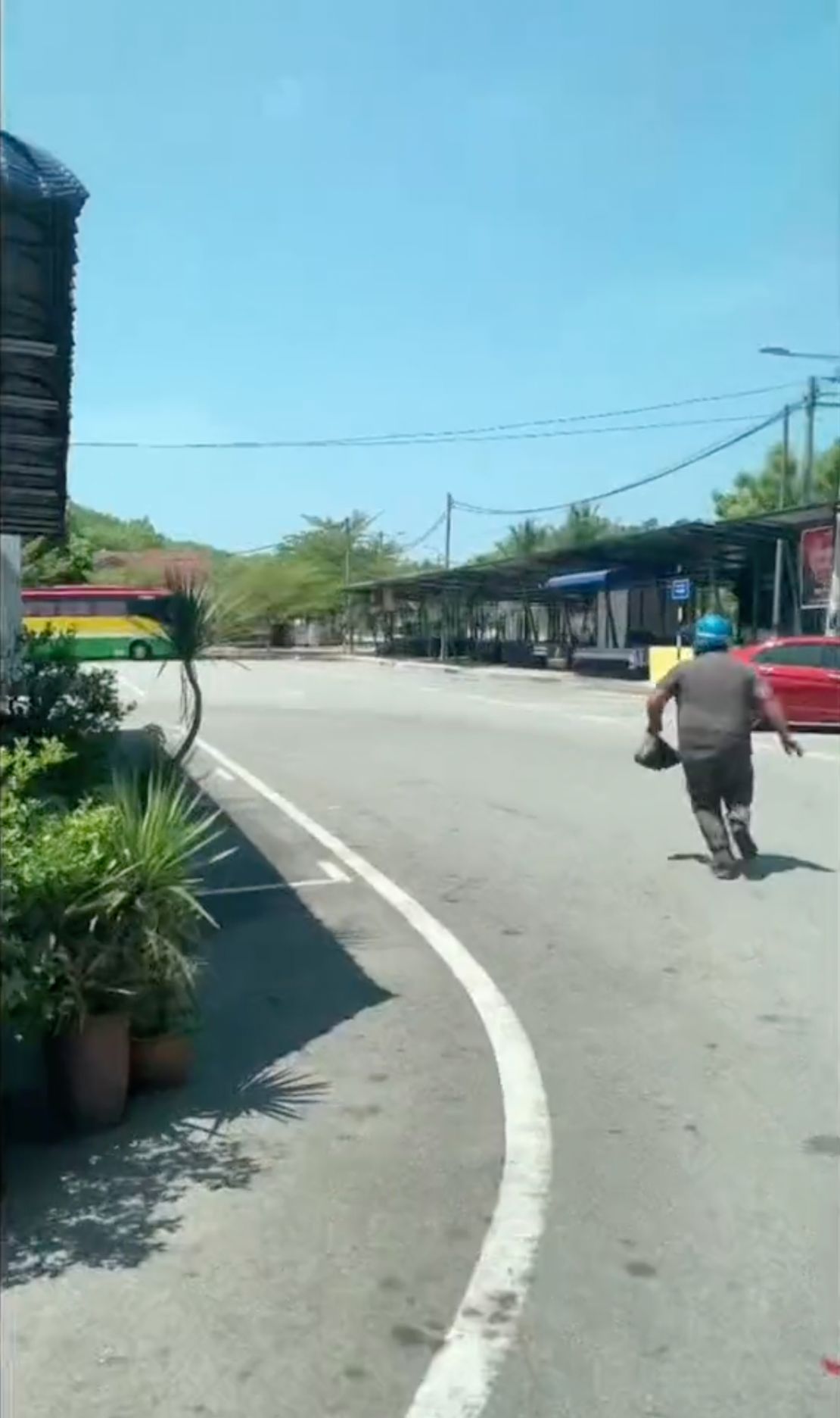 A man runs away from a religious police raid on a restaurant in the state of Perak. Image taken from a video of the raid that was released on TikTok by local authorities.