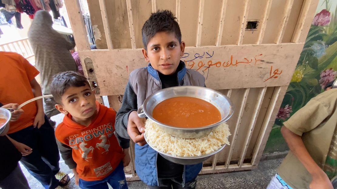 Zaki Sobeh (right), a young Palestinian boy, pictured at a shelter in Deir al-Balah, on Wednesday, told CNN he had not received a hot meal in over a month.
