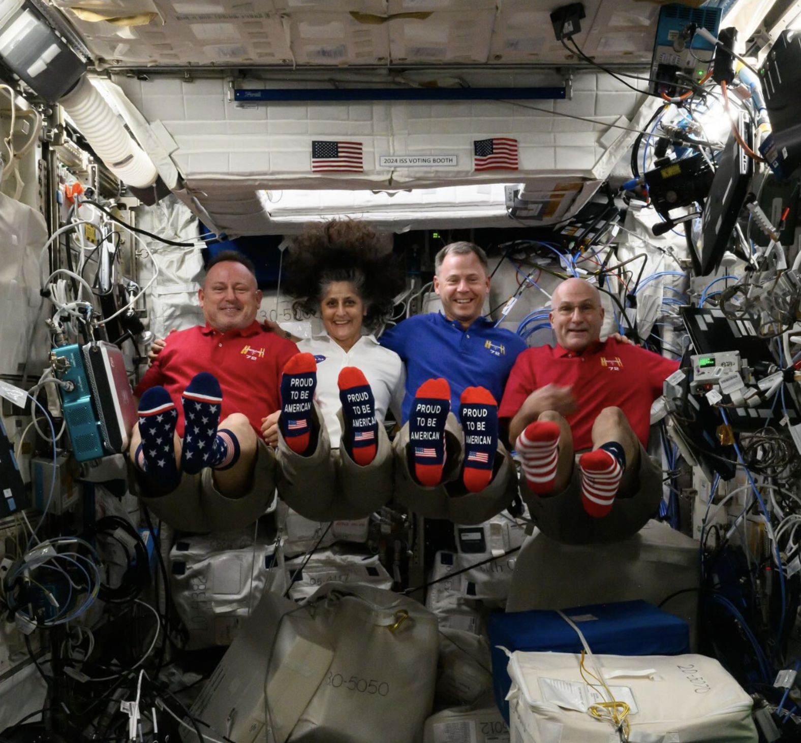 From left, NASA astronauts Butch Wilmore, Suni Williams, Nick Hague and Don Pettit show off their American-themed socks on the International Space Station. "It doesn’t matter if you are sitting, standing, or floating - what matters is that you vote!" Hague said in an <a href="https://www.instagram.com/p/DB_xhaLPXrx/" target="_blank">Instagram post</a> that came with the photo on Tuesday.