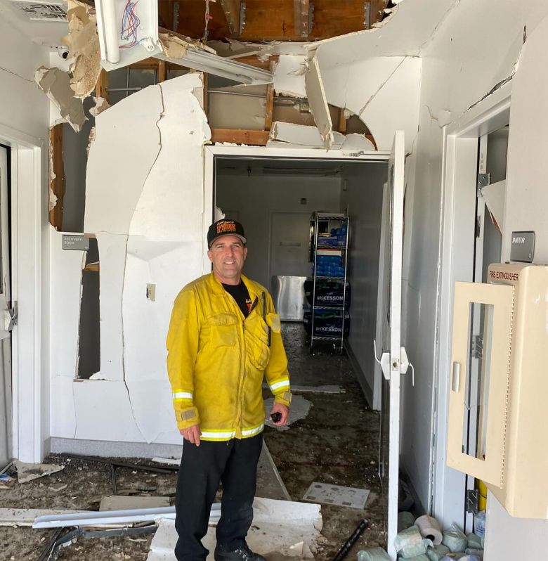 Deputy Fire Chief Greg Lyle stands inside the crumbling ARC clinic after helping restore power to embryo incubators.
