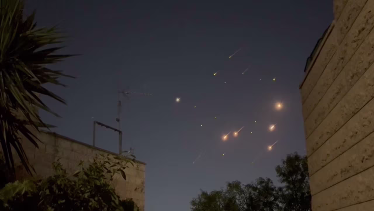 A still from a video shows missiles streaking across the sky over Jerusalem late Saturday.