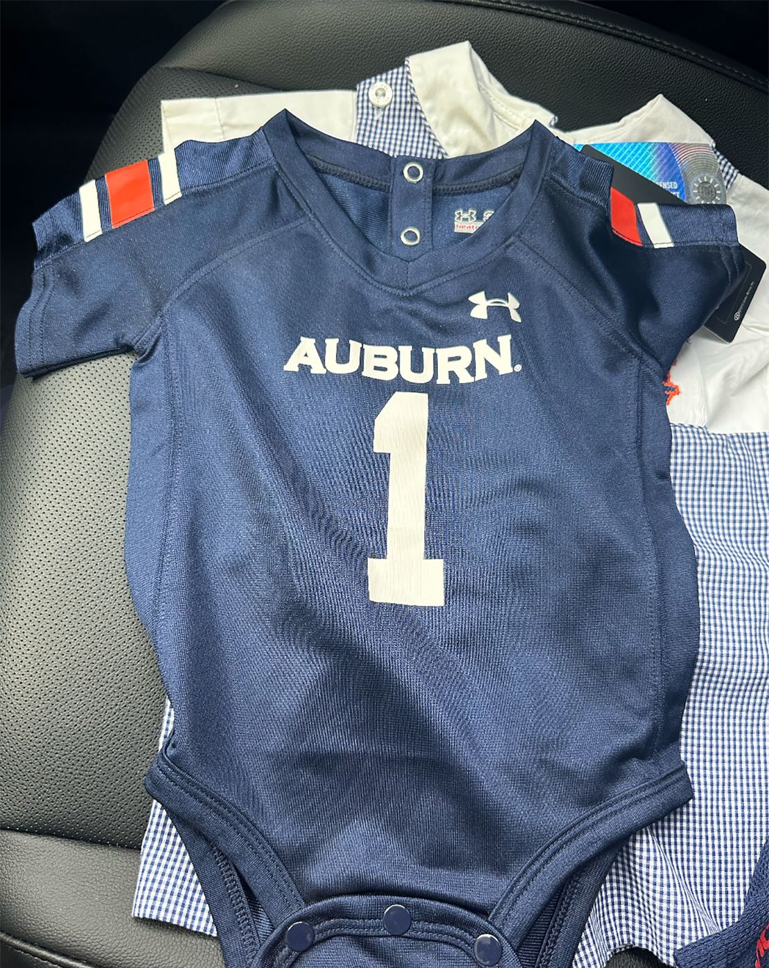 The Goidels are college football fans and bought an Auburn onesie for good luck ahead of their IVF journey.