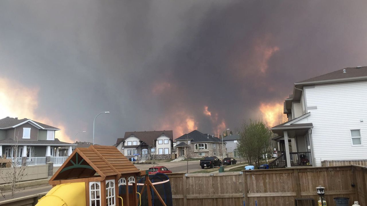 Flames and smoke fill the air as wildfires burn nearby in Fort McMurray, Alberta, Canada on May 2016.