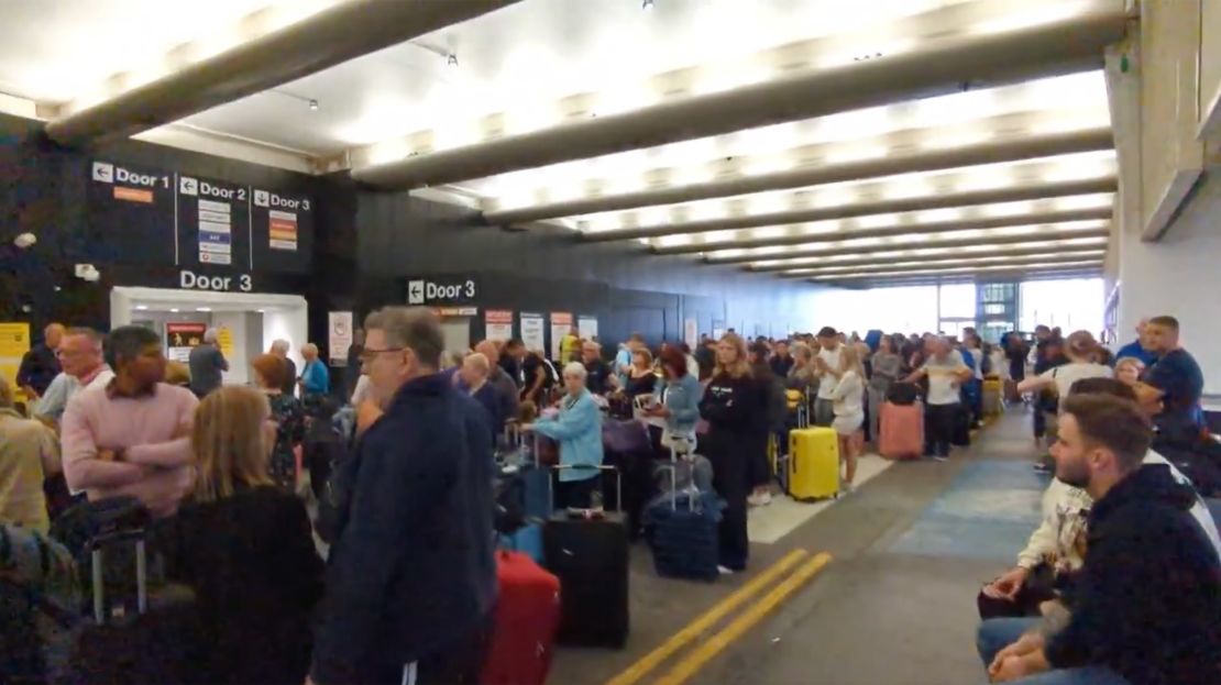 In a screengrab taken from a video, travelers wait around at Terminal One of the Manchester Airport in Manchester England on June 23, 2024, as a power cut let to disruptions and cancelations.
