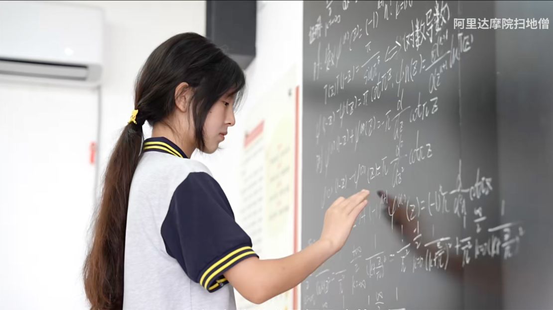 A screengrab from an official documentary shows Jiang solving a math problem on the blackboard.