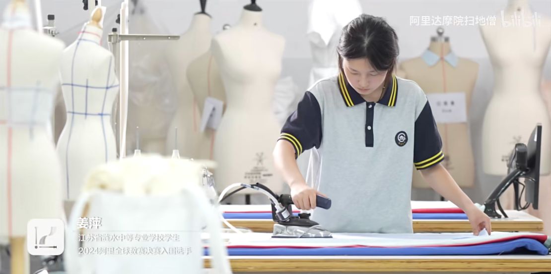 A screengrab from the documentary shows Jiang ironing clothes.