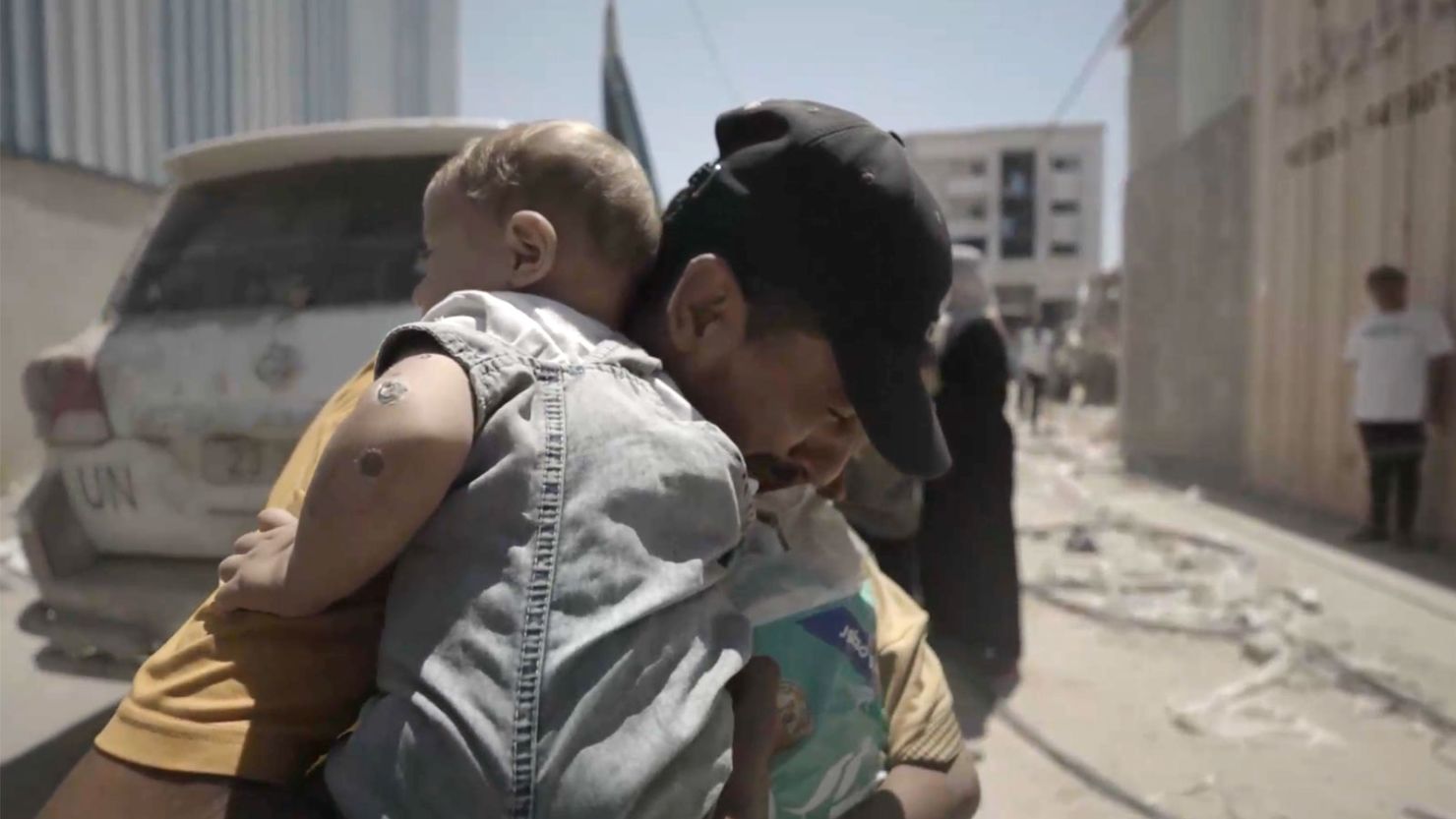 An image from a video provided by UNICEF shows Abdallah, reunited with his young children.