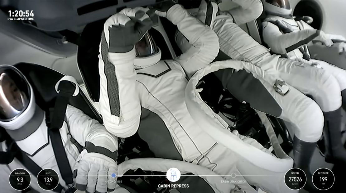 Polaris Dawn crew members are seen within the SpaceX Crew Dragon capsule.