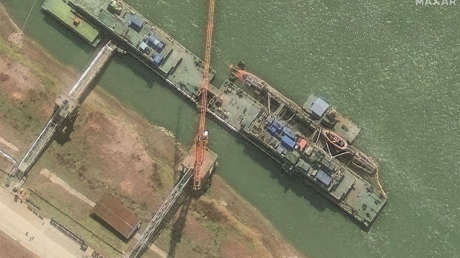 A satellite image from Maxar shows the Zhou class sub sitting at the pier on March 10.