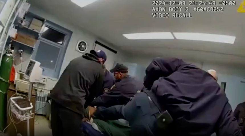 Robert Brooks is restrained by correctional officers at the Marcy Correctional Facility.