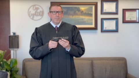 In this screengrab taken from a video, Judge Lawrence VanDyke holds a gun in a video uploaded on March 20, 2025 as a part of his dissent in 23-55805 Duncan v. Bonta, an opinion ruling that California’s law banning gun magazines that hold more than 10 rounds of ammunition can remain in place. The 9th US Circuit Court of Appeals ruled 7-4 that the law was permissible under the Second Amendment because large-capacity magazines are not considered “arms” or “protected accessories.”