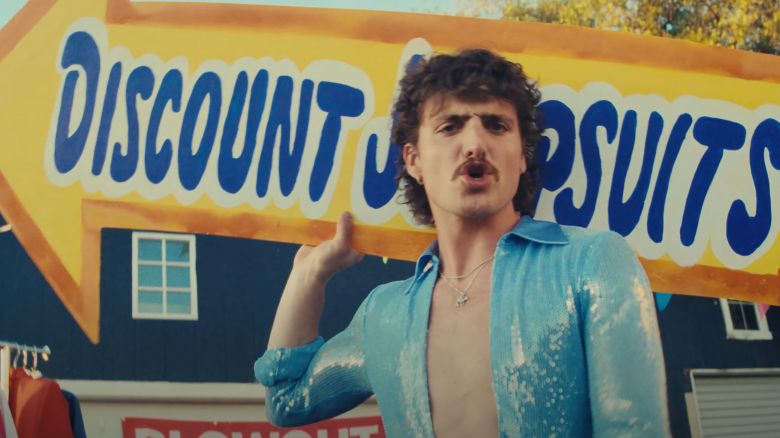Benson Boone is seen in his "Mr. Electric Blue" music video.